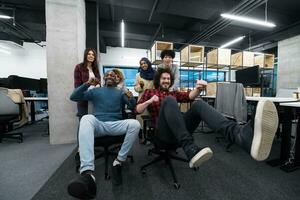 multiethnics business team racing on office chairs photo