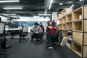 multiethnics business team racing on office chairs photo