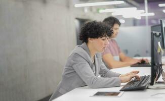 female software developer using desktop computer photo