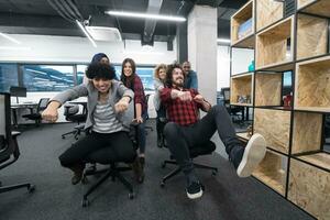 multiethnics business team racing on office chairs photo