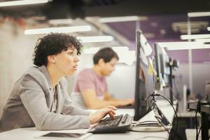 female software developer using desktop computer photo