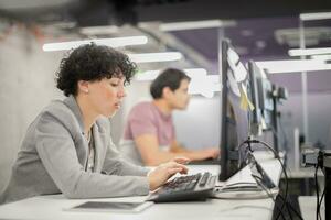 female software developer using desktop computer photo
