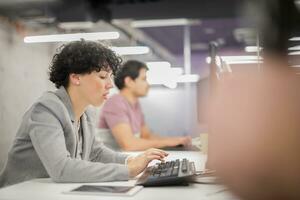 female software developer using desktop computer photo