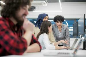 young multiethnics team of software developers working together photo