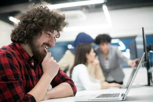 young multiethnics team of software developers working together photo