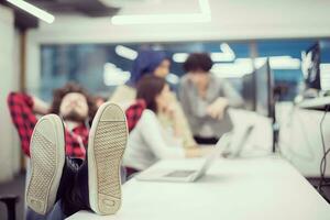 software developer resting with legs on desk photo