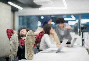 software developer resting with legs on desk photo