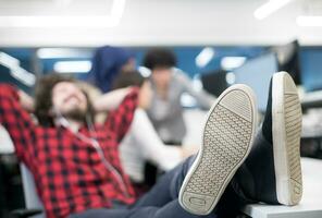 software developer resting with legs on desk photo