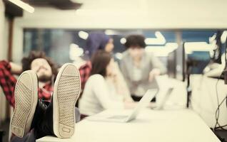 software developer resting with legs on desk photo