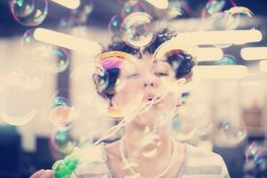 software developer having fun while making soap bubble photo