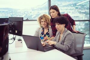 female software developers using laptop computer photo