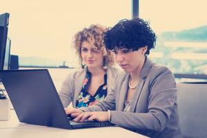 female software developers using laptop computer photo