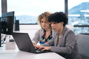 female software developers using laptop computer photo