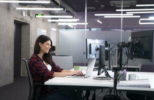 female software developer using laptop computer photo