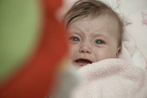 cute little baby playing with hands and smiling photo