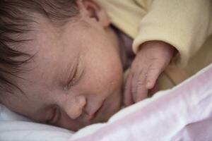 newborn baby sleeping in  bed at hospital photo