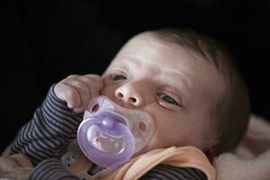 One month newborn baby sleeping  in bed photo