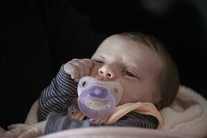 One month newborn baby sleeping  in bed photo