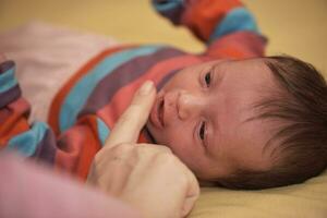 One month newborn baby sleeping  in bed photo