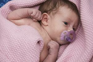 One month newborn baby sleeping  in bed photo