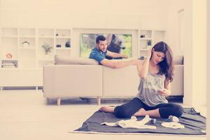 pregnant couple checking a list of things for their unborn baby photo