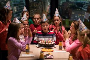 happy young boy having birthday party photo