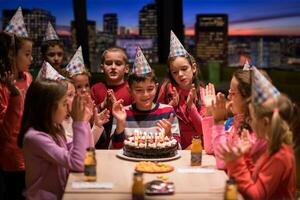 happy young boy having birthday party photo