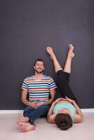 pregnant couple relaxing on the floor photo