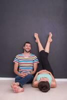 pregnant couple relaxing on the floor photo