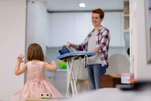 mother and little daughter spending time together at home photo