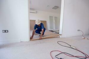 carpenters installing glass door with a wooden frame photo