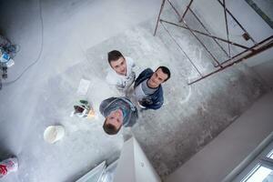 top view of Workers and builders with dirty uniform in apartment photo