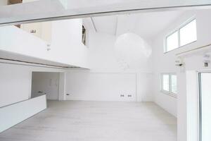 Interior of empty stylish modern open space two level apartment photo