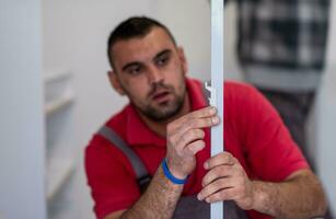 worker installing a new kitchen photo