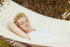 young woman resting on hammock photo