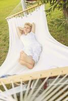 young woman resting on hammock photo