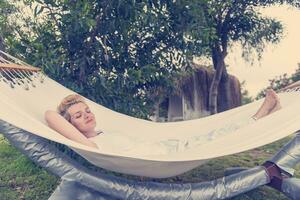 young woman resting on hammock photo