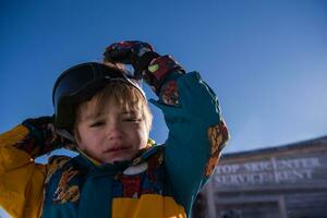 little boy having a problem with ski goggles photo