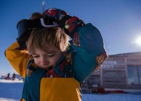 little boy having a problem with ski goggles photo