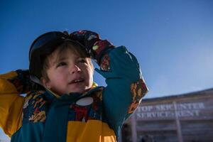 little boy having a problem with ski goggles photo