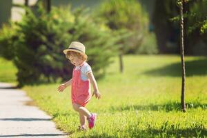 little girl runing in the summer Park photo