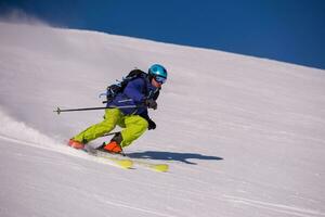 Skier having fun while running downhill photo