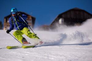 Skier having fun while running downhill photo