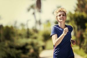 young female runner training for marathon photo