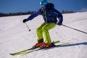 Skier having fun while running downhill photo