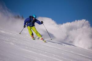 Skier having fun while running downhill photo