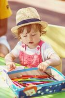 little girl drawing a colorful pictures photo