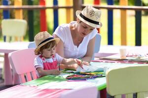 mom and little daughter drawing a colorful pictures photo