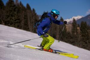 Skier having fun while running downhill photo