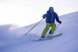 Skier having fun while running downhill photo